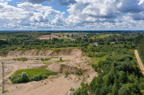 Aerial view of old gravel quarry and cloudy sky