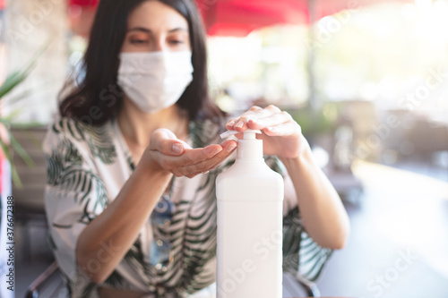 woman washing hand in cafe using disinfectant. Hygiene first
