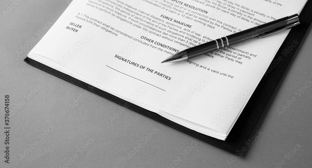Signature and pen on business contact. black and white image Signature and pen on business contact. black and white image