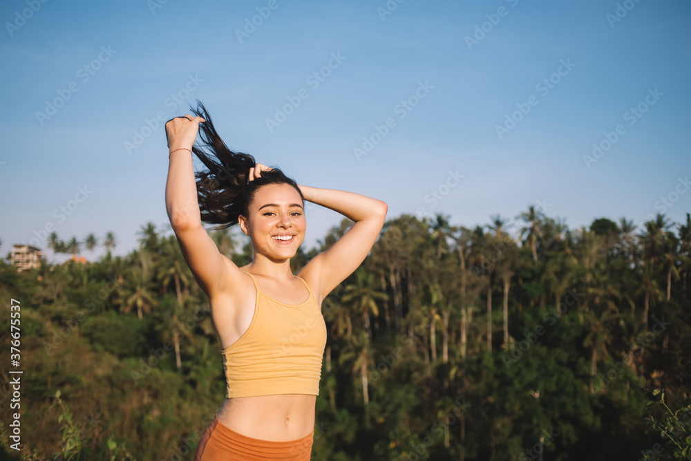 Cheerful caucasian female in activewear feeling energy and joy after training on nature in morning, smiling young hipster girl satisfied with healthy lifestyle care about body and mental health Cheerful caucasian female in activewear feeling energy and joy after training on nature in morning, smiling young hipster girl satisfied with healthy lifestyle care about body and mental health