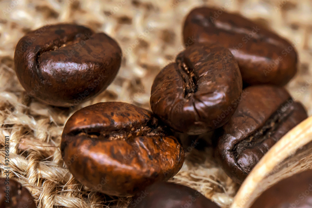 Obraz premium Coffee beans. Macro photo Burlap fabric. Rough fabric texture. Fabric Canvas. Coffee beans on sacking. Coffee abstraction.
