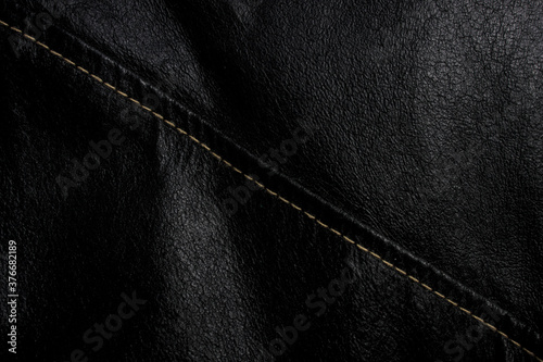 Black leather texture background with seam