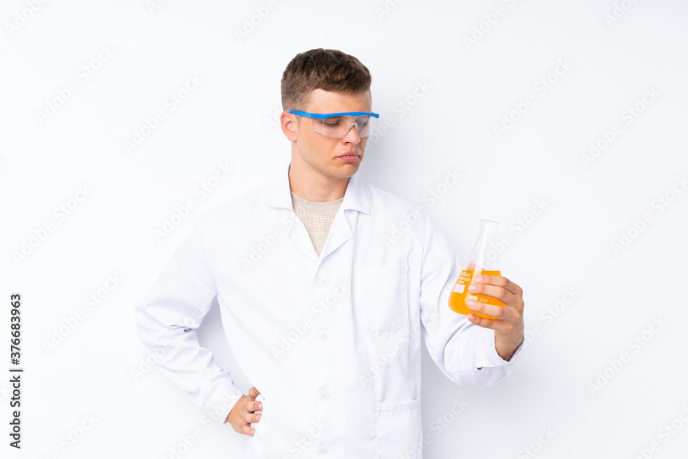 Young handsome man over isolated white background with a scientific test tube Young handsome man over isolated white background with a scientific test tube