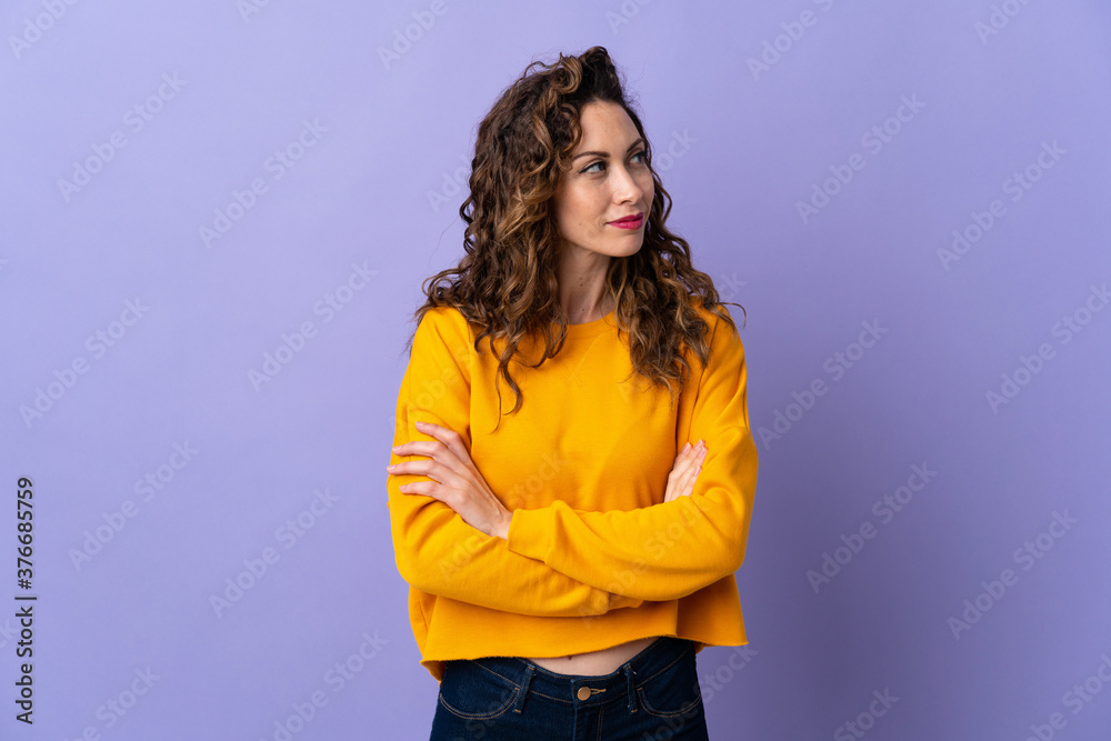 Young caucasian woman isolated on purple background looking to the side Young caucasian woman isolated on purple background looking to the side
