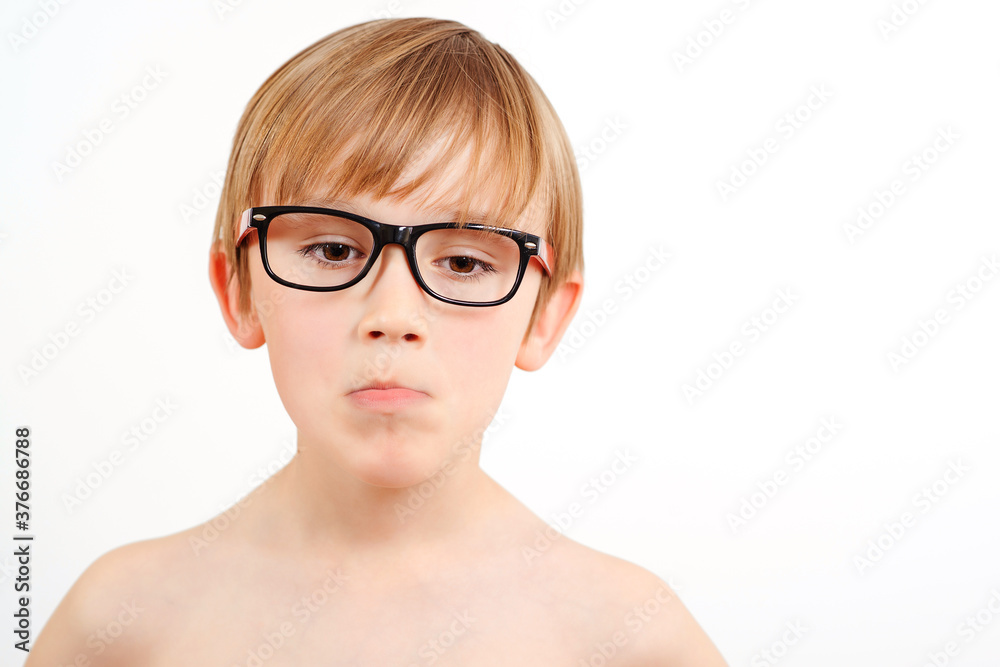 Sad child wearing glasses on white background. Childhood. Sad child wearing glasses on white background. Childhood.