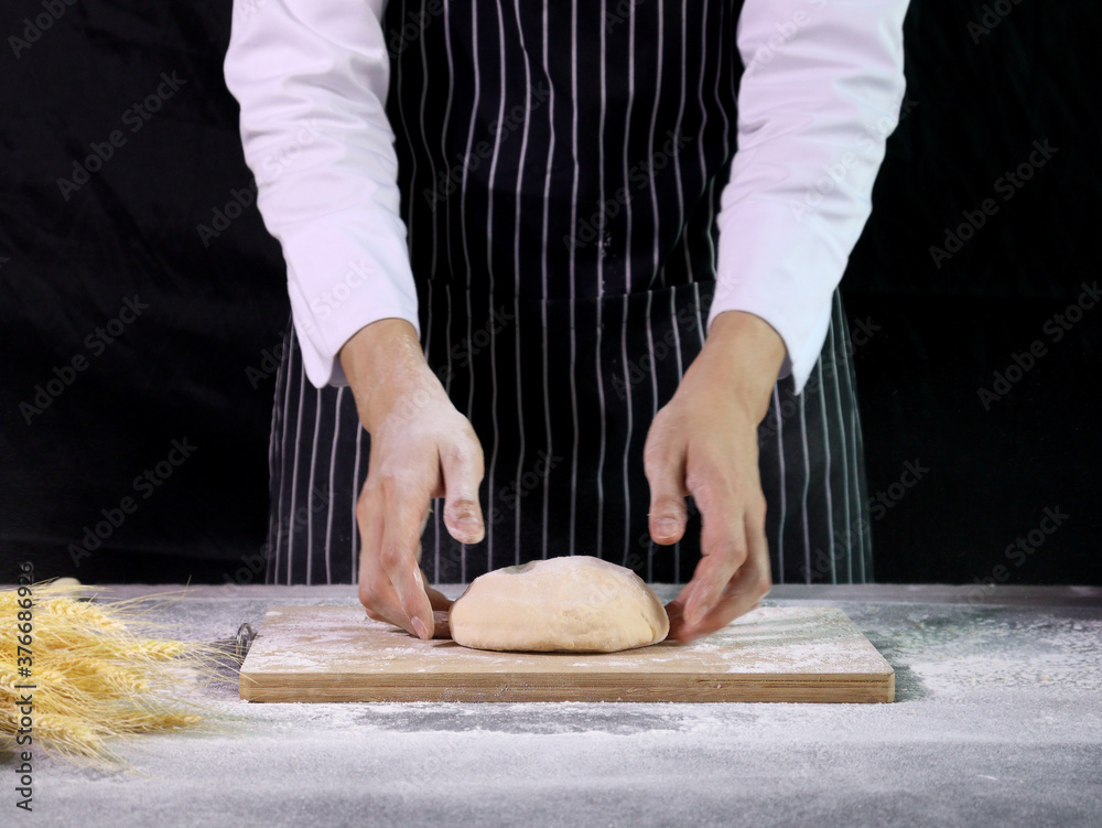 Hands preparing bread dough, kneading the dough. Hands with flour splash, food homemade bakery concept Hands preparing bread dough, kneading the dough. Hands with flour splash, food homemade bakery concept