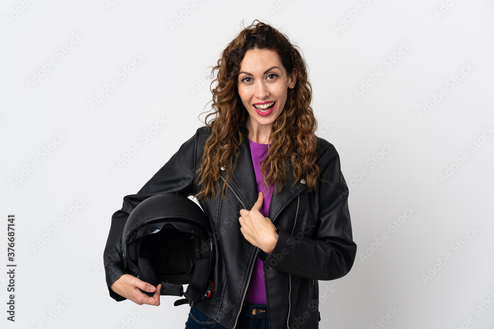 Young caucasian woman holding a motorcycle helmet with surprise facial expression Young caucasian woman holding a motorcycle helmet with surprise facial expression