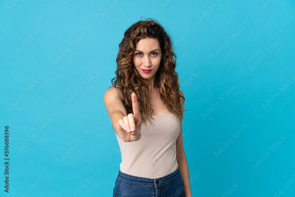 Young caucasian woman isolated on blue background showing and lifting a finger Young caucasian woman isolated on blue background showing and lifting a finger