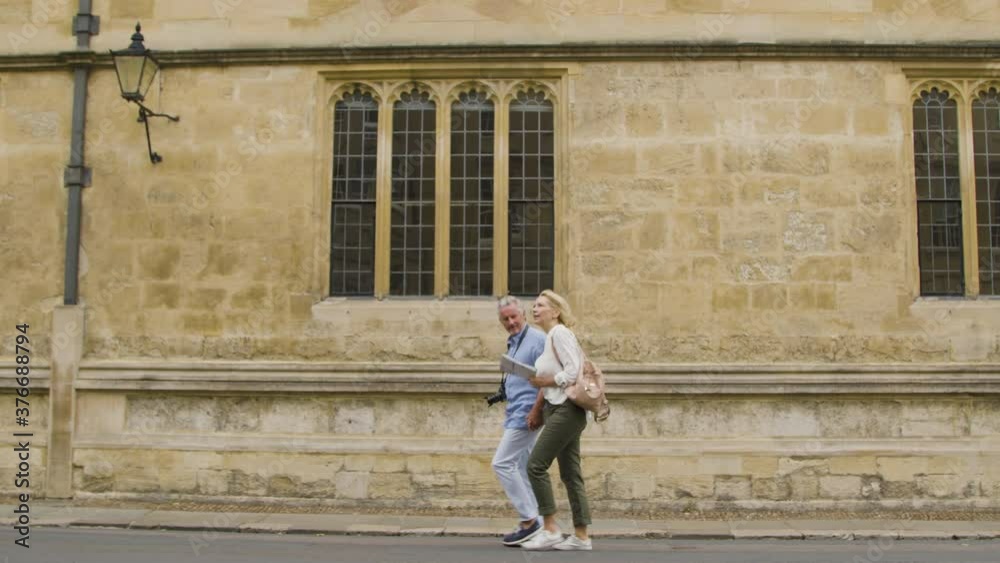 Tracking Shot of Middle Aged Couple Holding Hands Exploring Oxford Tracking Shot of Middle Aged Couple Holding Hands Exploring Oxford