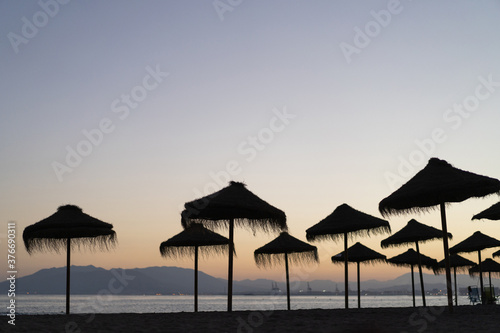 beach umbrellas in the sunset © Anna