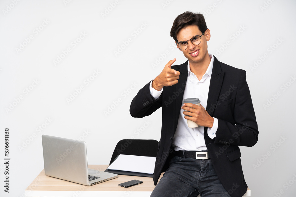 Businessman in his office over isolated white background points finger at you Businessman in his office over isolated white background points finger at you