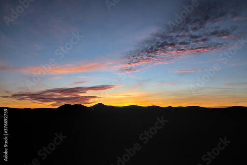 Sunset over the mountains. Beauty of blue hour. Evening silhouettes of Wicklow Mountains and magic sunset viewed from Bray Head, County Wicklow, Ireland