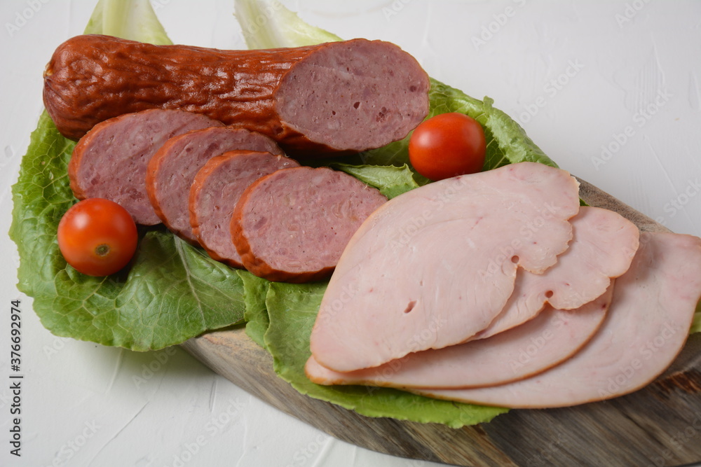 Sliced spicy smoked beef/ pork sausage and turkey pastrami slices. With lettuce leaf and basil,cherry tomatoes. Sliced spicy smoked beef/ pork sausage and turkey pastrami slices. With lettuce leaf and basil,cherry tomatoes.