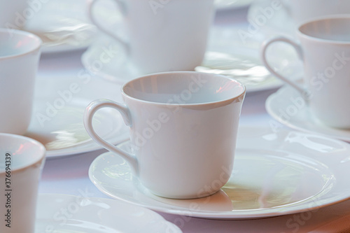 Empty white coffee cups or tea cups in rows.