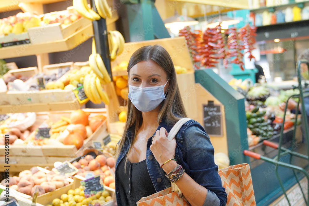 Woman at fresh food market wearing face mask