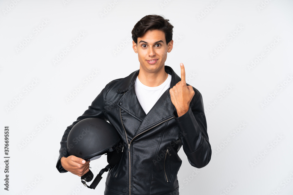 Man holding a motorcycle helmet over isolated white background pointing with the index finger a great idea Man holding a motorcycle helmet over isolated white background pointing with the index finger a great idea