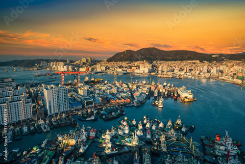 Busan skyline and pier at sunset in Busan, South Korea. © nuttawutnuy