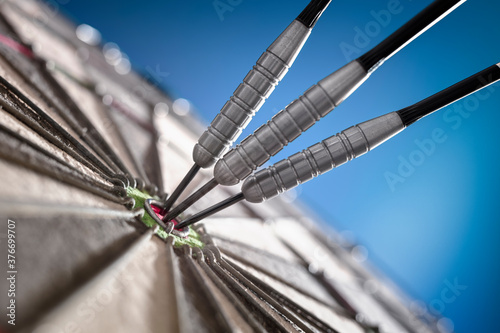 Cuadro en lienzo Darts in bullseye of dartboard concept for hitting target, perfection and succes