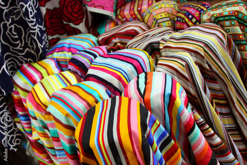 rolls of stripe patterns fabric, polyester textiles in shop or factory, Concept image for clothing trend and style or garment manufacturing.