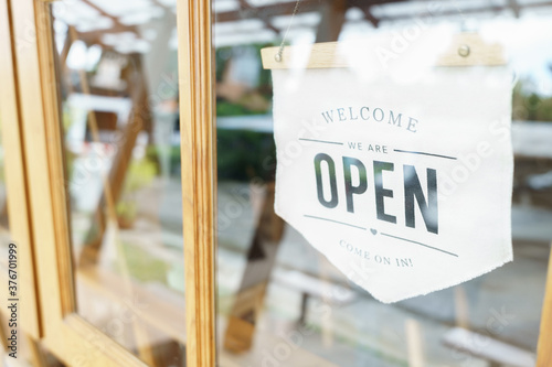Welcome Open sign broad through the glass of window at coffee shop. shop ready to service, cafe restaurant, retail store, small business owner, food and drink concept