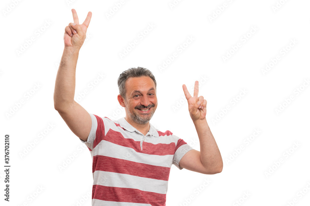 Friendly male model making peace or victory sign with fingers Friendly male model making peace or victory sign with fingers