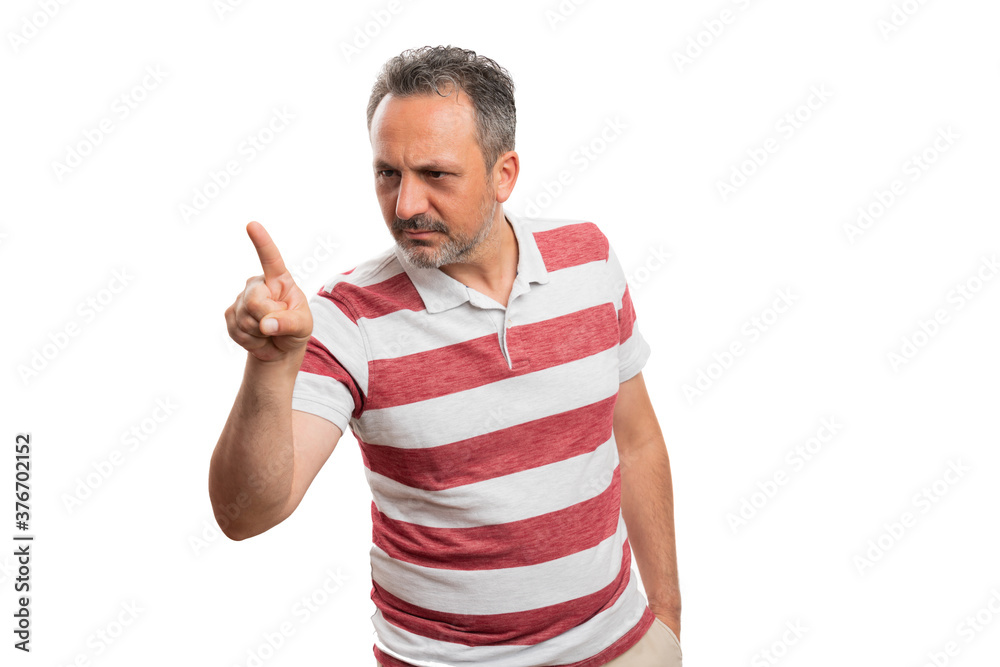 Man with focused expression pointing index finger at copyspace Man with focused expression pointing index finger at copyspace