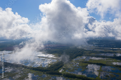 Aerial view of flooded Seda swamp (Sedas purvs) water lakes and clouds