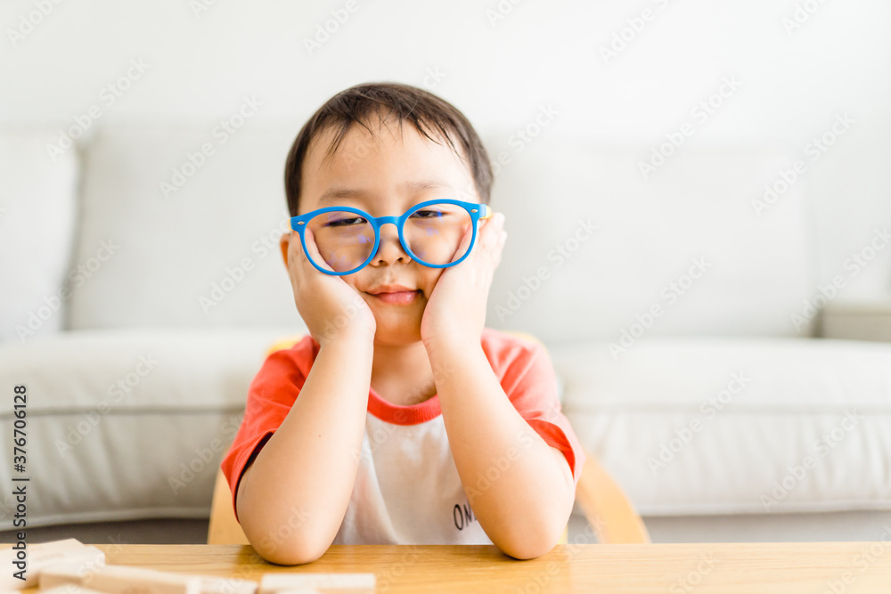 stressed out and tired asian kids boy stay at home and learn from home.Nerd boy wearing glasses with tired face and boring.Online learning at home.Nerd boy, Counting Education,Mental Healthcare. stressed out and tired asian kids boy stay at home and learn from home.Nerd boy wearing glasses with tired face and boring.Online learning at home.Nerd boy, Counting Education,Mental Healthcare.
