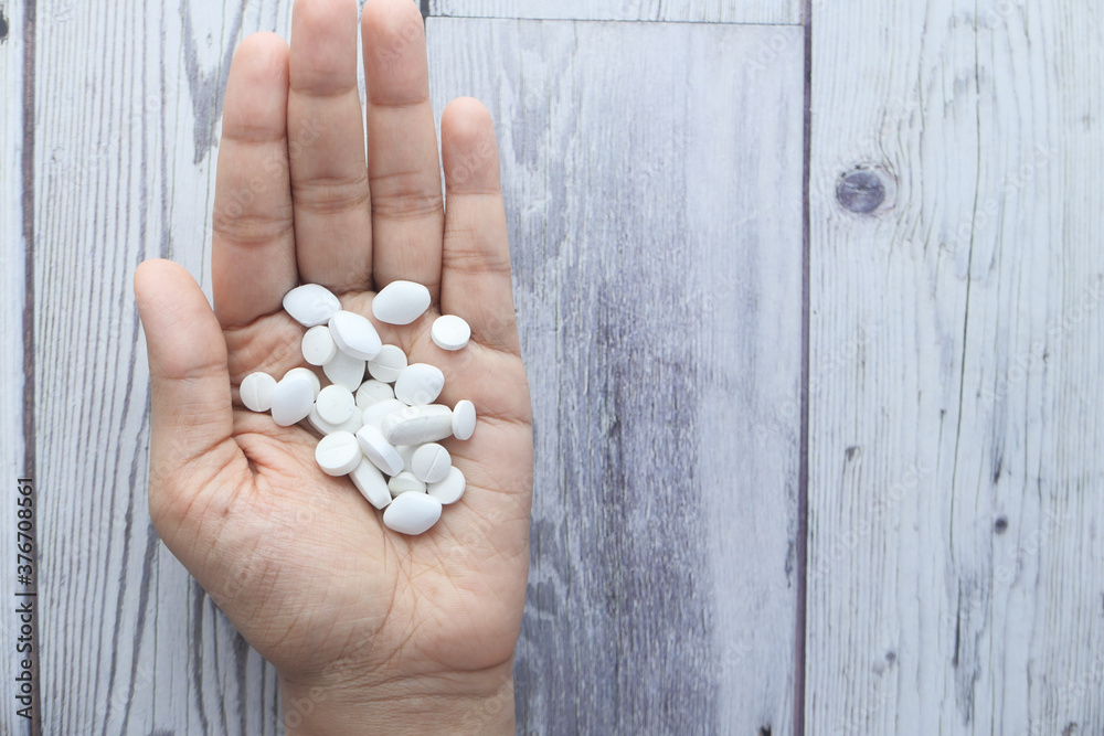 Close up of women hand taking pills Close up of women hand taking pills