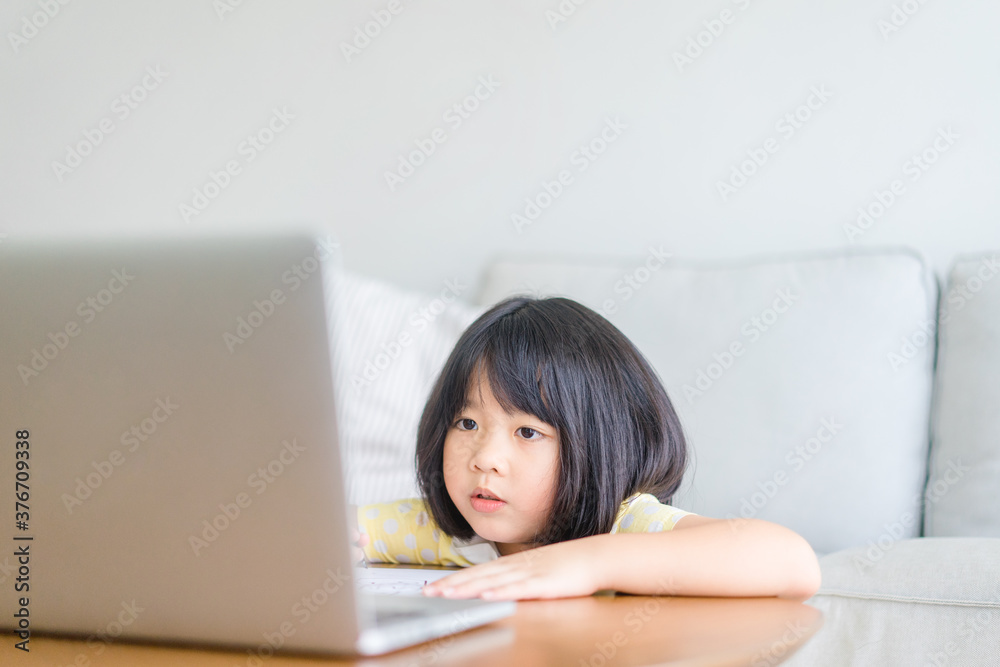 Asian girl student online learning class study online video call zoom teacher, Happy girl learn english language online with laptop at home.New normal.Covid-19 coronavirus.Social distancing.stay home. Asian girl student online learning class study online video call zoom teacher, Happy girl learn english language online with laptop at home.New normal.Covid-19 coronavirus.Social distancing.stay home.