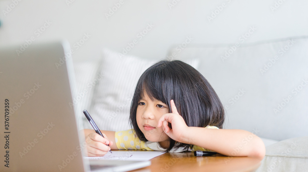 Asian girl student online learning class study online video call zoom teacher, Happy girl learn english language online with laptop at home.New normal.Covid-19 coronavirus.Social distancing.stay home. Asian girl student online learning class study online video call zoom teacher, Happy girl learn english language online with laptop at home.New normal.Covid-19 coronavirus.Social distancing.stay home.