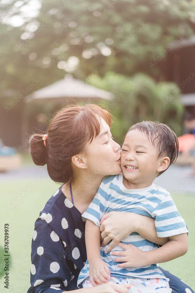 Portrait of asian mother and toddler boy child playing having fun together. Happy son and mom laughing and kissing in playground outdoor.Love family lifestyle single mom.Mother’s day holiday concept. Portrait of asian mother and toddler boy child playing having fun together. Happy son and mom laughing and kissing in playground outdoor.Love family lifestyle single mom.Mother’s day holiday concept.