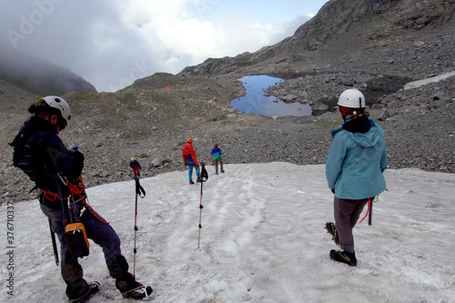 Climbers at the training camp. Climbers train to walk in crampons on the glacier. Caucasus.