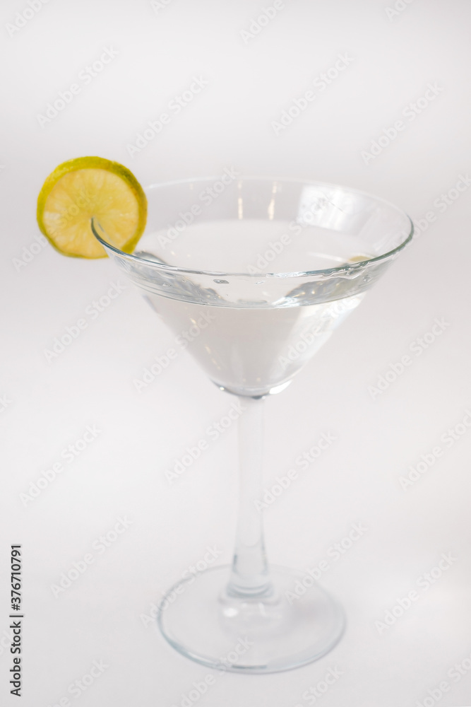 Glass of vermouth decorated with a lime slice.