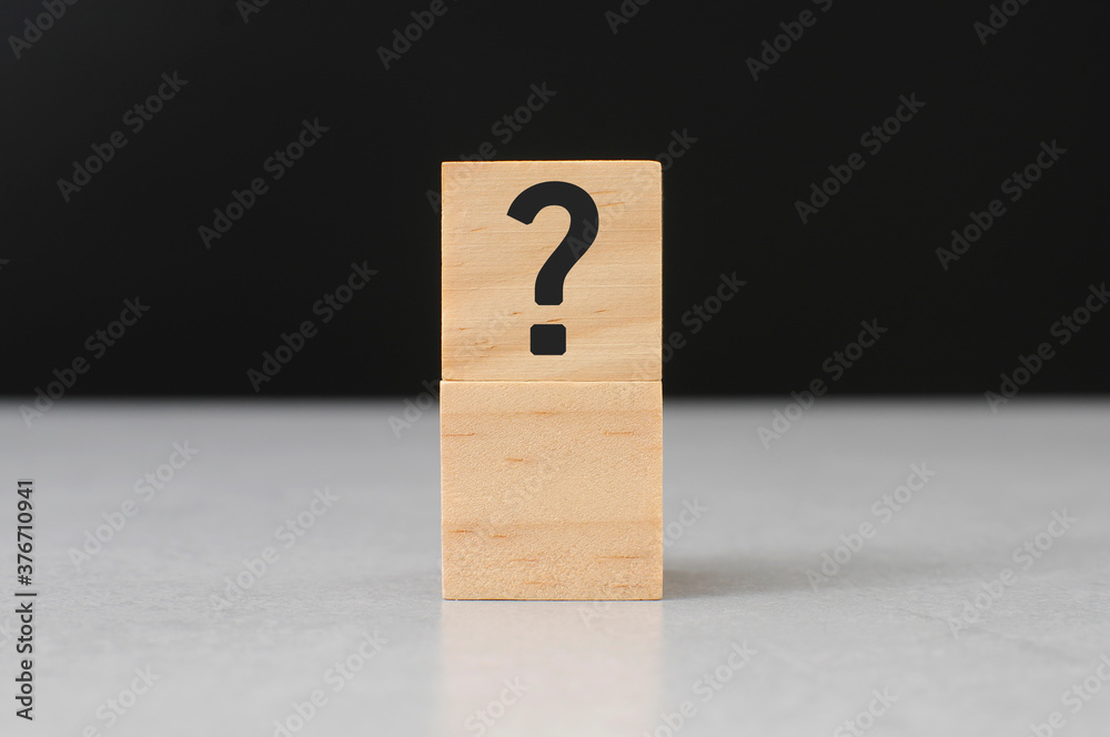 question mark sign on wooden block cement top black background question mark sign on wooden block cement top black background