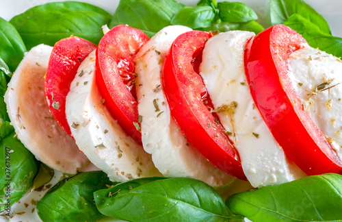 caprese salad  with buffalo mozzarella, tomato and basil with olive oil photo