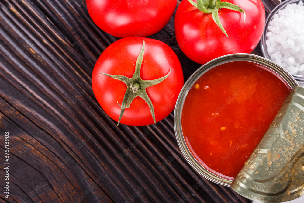 juicy canned tomatoes on wooden rustic background