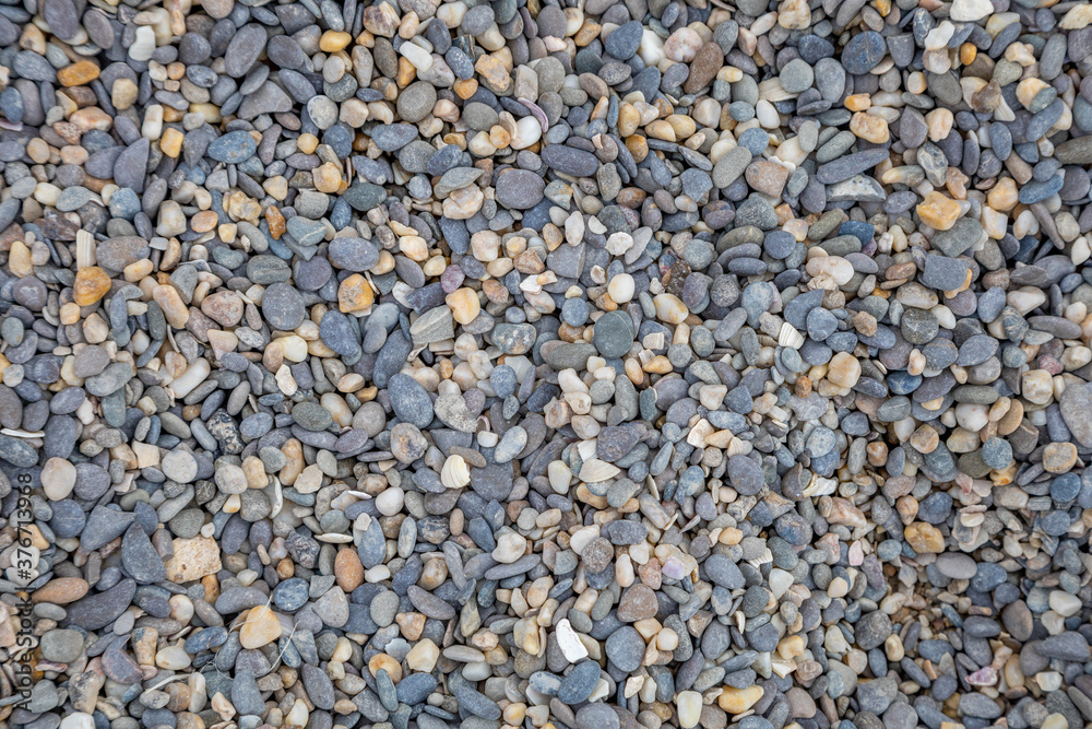 pebble texture on the beach. gray-white stones pebble texture on the beach. gray-white stones