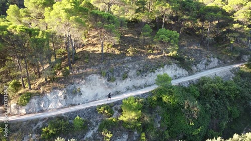 Hiker walking on the mountain, plane with drone