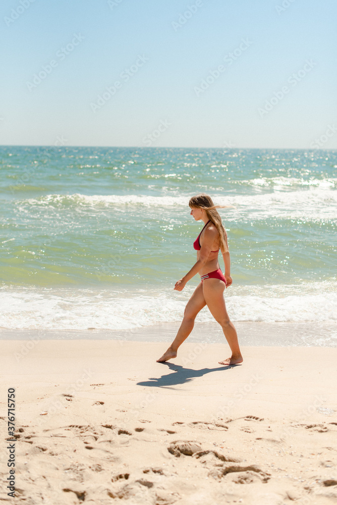 young woman walking on the beach young woman walking on the beach