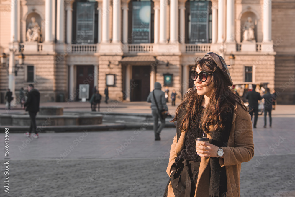 portrait of stylish gorgeous woman in coat outdoors drinking coffee to go portrait of stylish gorgeous woman in coat outdoors drinking coffee to go