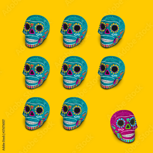 Colorful mexican skulls on a yellow background