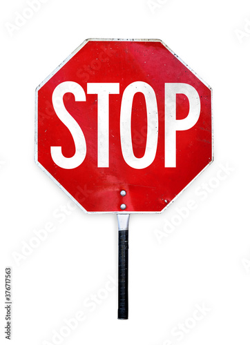 Aged hand-held stop sign or paddle used for traffic control by crossing guards, police or work zones. Red and white metal texture sign in octagon shape and a pole to hold. Isolated on white.