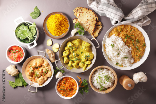 assortment of indian dish- naan, curry chicken, rice, tikka masala