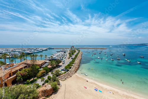 High view of Portals beach, Mallorca, next to the port, blue sky and white clouds