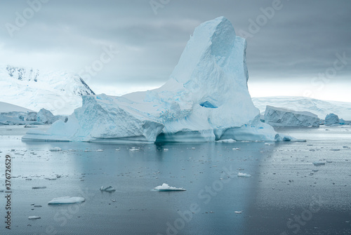 Antarctica, Antarctic Peninsula Area, Mountain and amazing Iceberg surrounded by ice floes. February 2020