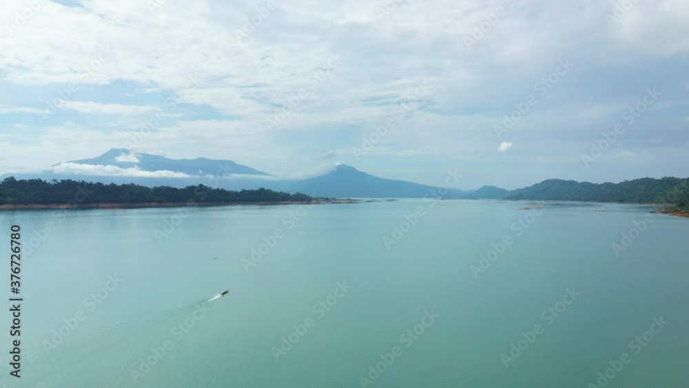 The reservoir on the Nam Ngum surrounded by mountains in Asia, Laos, towards Vientiane, on a sunny day.