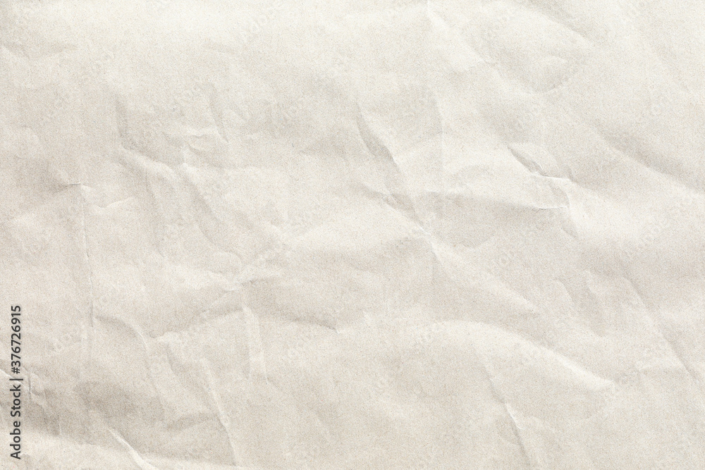 Crumpled pale brown background paper texture