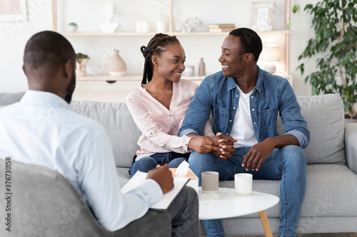 Successful Couples Therapy. Reconciled black spouses embracing at therapist office © Prostock-studio