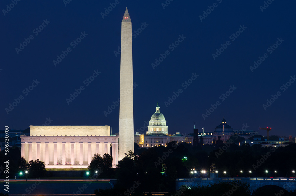 Washington D.C. skyline at night with major monuments including  U.S. Capitol and Lincoln Memorial and Washington Monument
